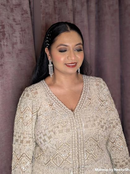 A classic party glam look with a soft brown smokey eye and sleek hair. This is a versatile style that works beautifully for any evening celebration, from a Sangeet to a reception.