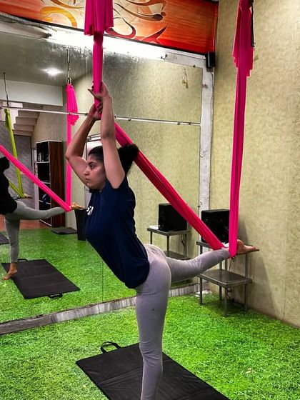 Get ready to soar. This student is practicing a standing balance with the support of the hammock, a great way to build stability.