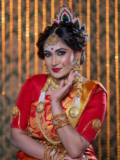 A close-up of the Bengali bridal makeup, showing the detail in the eye makeup and the traditional jewellery. The expression is one of grace and confidence.