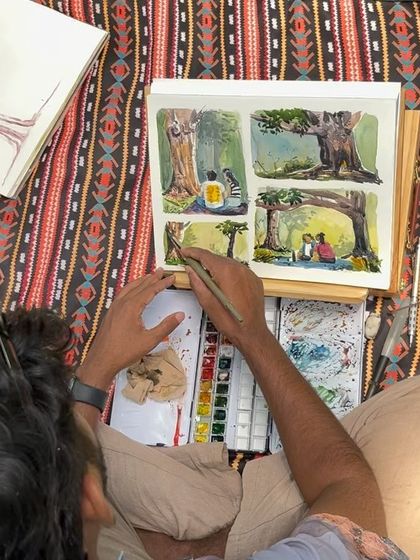 An overhead shot of me working on the four-panel Cubbon Park painting. You can see my process of laying down colors and adding details.