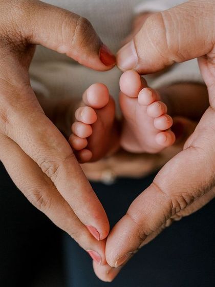 It's all about the tiny details. Parents' hands forming a heart around their newborn's feet is one of my favorite shots to capture.