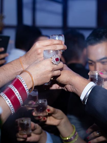 A group of guests, including the bride, raising their glasses for a toast. My goal is to be at the center of these happy moments, providing the drinks that fuel the celebration.