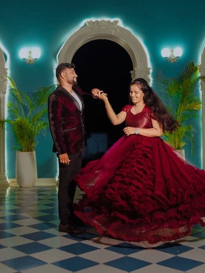 Another angle of this romantic dance, showing how the ruffled layers of the red ball gown add texture and volume, making it a stunning choice for a pre-wedding celebration.