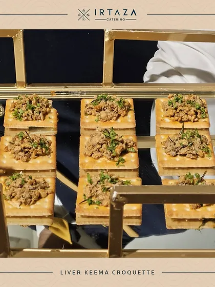 Liver Keema Croquettes served on crisp crackers. This savory and rich appetizer is presented on a two-tiered golden stand, making it an elegant addition to any menu.