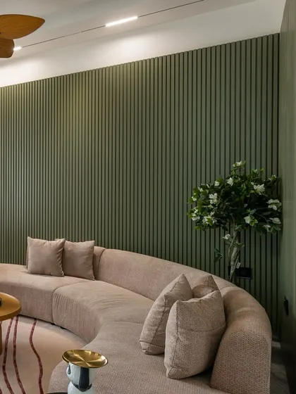 Another angle of the living room, showing the texture of the curved sofa and the depth created by the fluted wall paneling.