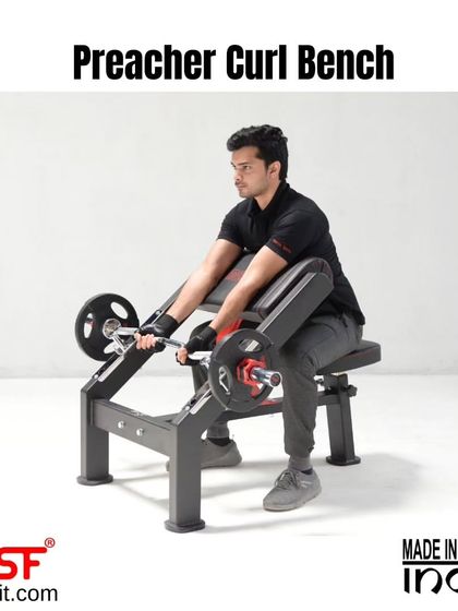 Another angle of a user on the Preacher Curl Bench.