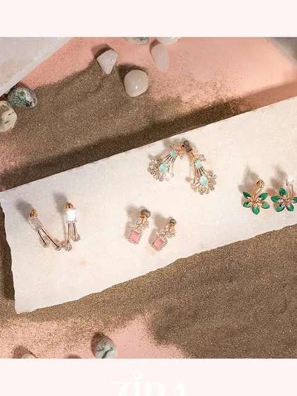 A selection of our Zira diamond earrings, showcasing various designs from simple studs to colorful drops.