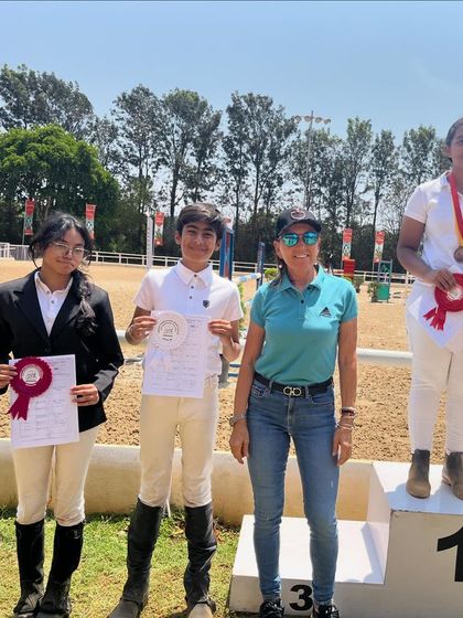 Our young riders proudly displaying their ribbons and certificates on the podium. We focus on building a strong foundation, which leads to early success and a lifelong passion for the sport.