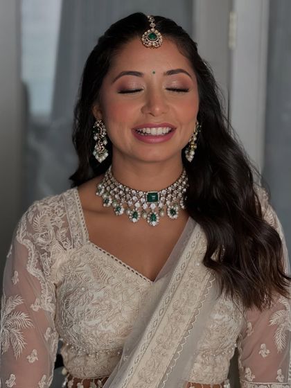A close up with her eyes closed, showcasing the delicate pink and brown eyeshadow blend. It's a perfect example of a soft glam look that enhances without overpowering.