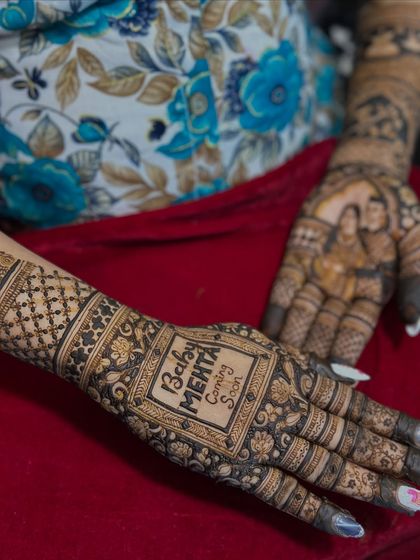 A different perspective of the personalized baby shower mehendi, showing both the announcement and the couple portrait.