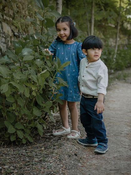 Two siblings exploring nature together during their outdoor photoshoot.