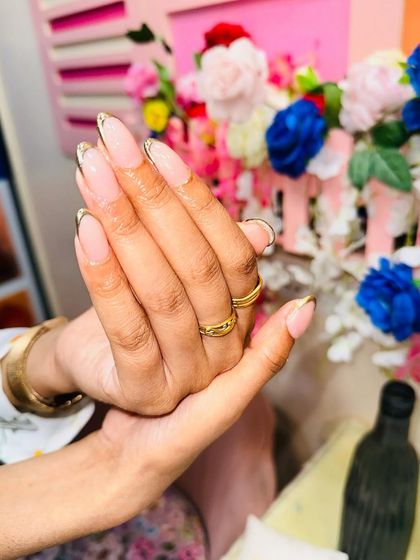 A full view of the hand with the chrome French manicure, showing how the design elongates the fingers.