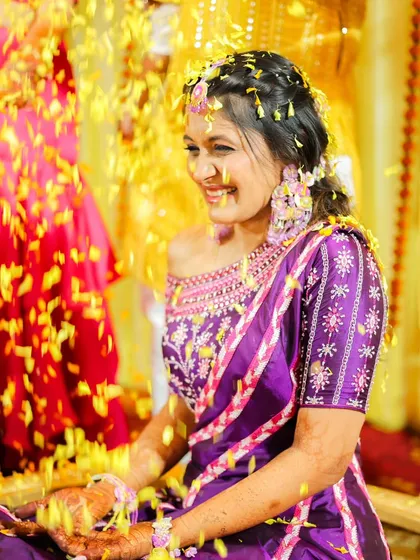 A beautiful portrait of the bride enjoying the flower shower, her smile lighting up the frame.