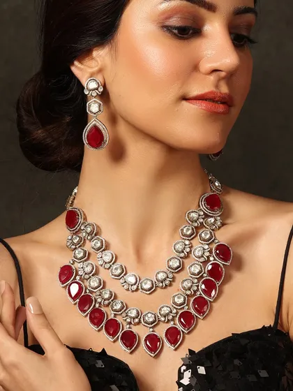 A bold statement in red. This three-tiered ruby and polki necklace set is designed for the bride who isn't afraid to embrace color and drama.