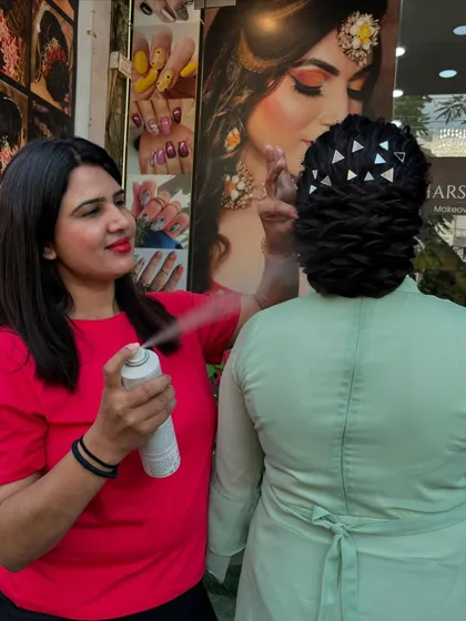 Our hairstylist Ritu at work, setting a textured bun with hairspray to ensure it lasts all day and night.