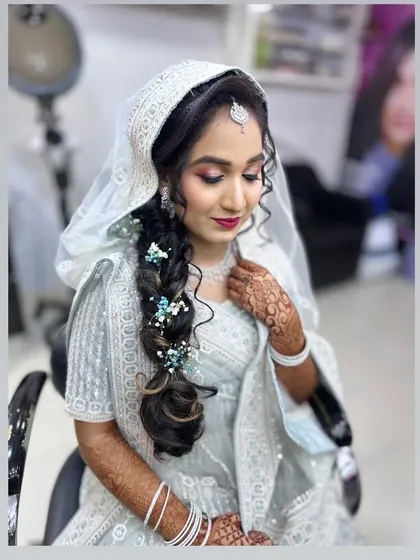 The full look for my engagement client. The mermaid braid is decorated with small blue flowers to match her beautiful light blue outfit.