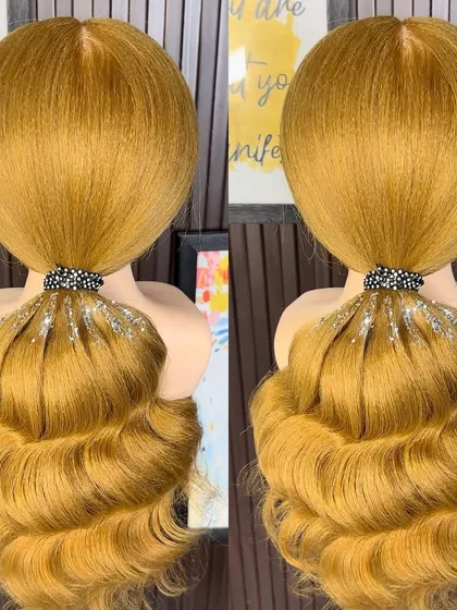 A sleek high ponytail with Hollywood waves and a touch of glitter at the base.