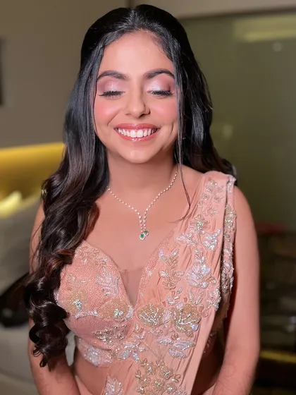 Her joyful expression says everything. The soft glam makeup enhances her natural beauty and happiness, making her shine on her special evening.