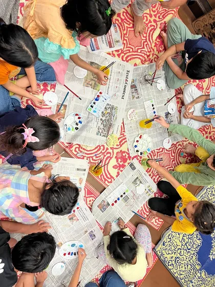 This is what hands-on learning looks like. After a story, children get to express their creativity through a related craft, like this papier-mâché painting session. It helps them connect with the story on a deeper, more personal level.
