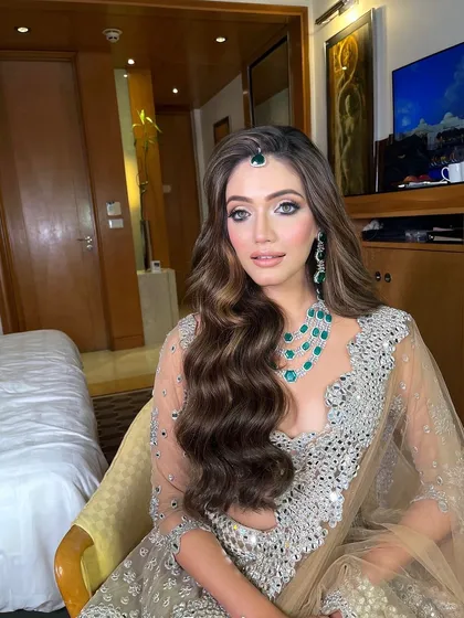 A stunning look for a reception or cocktail party. I styled the hair in deep, glossy waves, swept to one side to beautifully complement the statement emerald necklace and off shoulder outfit.