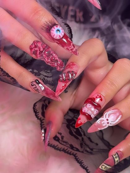 The ultimate horror movie inspired nails, with a 3D eyeball, exposed teeth, and "HELP" text. Perfect for Halloween.