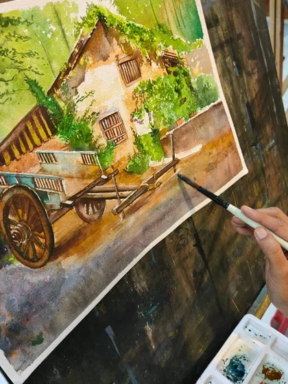 A detailed shot of the brush applying color to the paper, capturing a moment of creation in this beautiful watercolor piece.