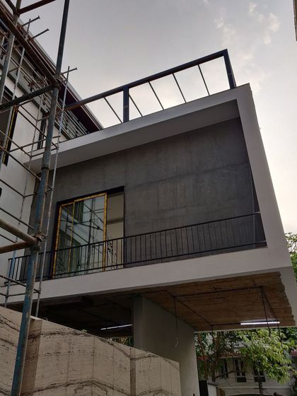 A duplicate image of a residential facade during construction.