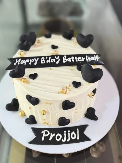A cake for your "better half," decorated with black hearts and gold leaf on a textured buttercream base.