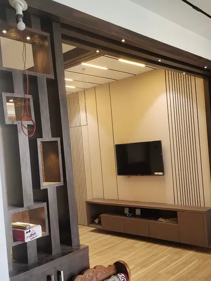 A view from the side, showing the partition and the TV unit structure before final finishing. This helps illustrate the solid framework behind the beautiful facade.