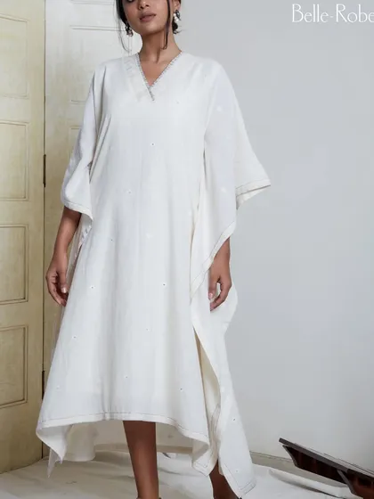A full-length view of the look for Belle Robe. The natural makeup style ensures the focus remains on the flowing silhouette and delicate details of the white dress.
