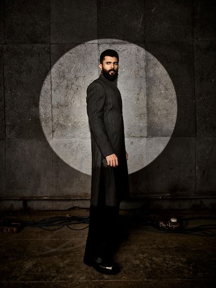 A side profile of Vijay's Anamika Khanna look, emphasizing the long, clean lines of the garment.