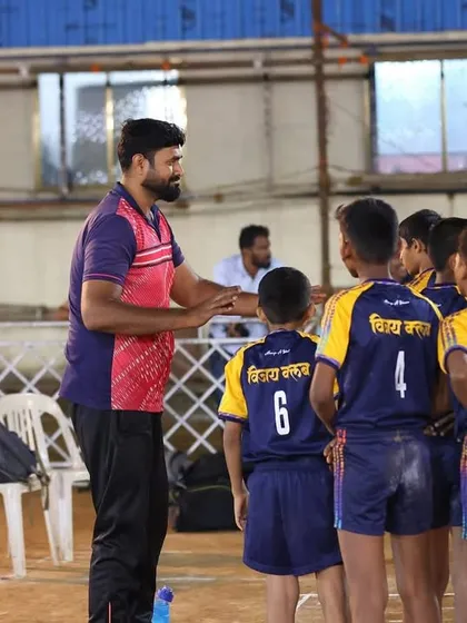 A coach giving strategic instructions to our Under-14 team during a timeout.