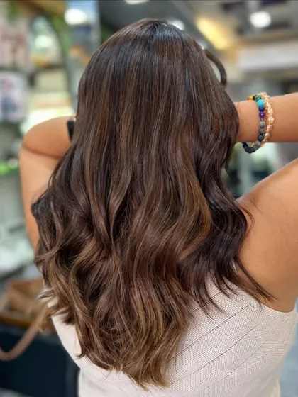 From the back, you can see the soft, natural waves and how the caramel pieces are scattered throughout for a sun-kissed effect.
