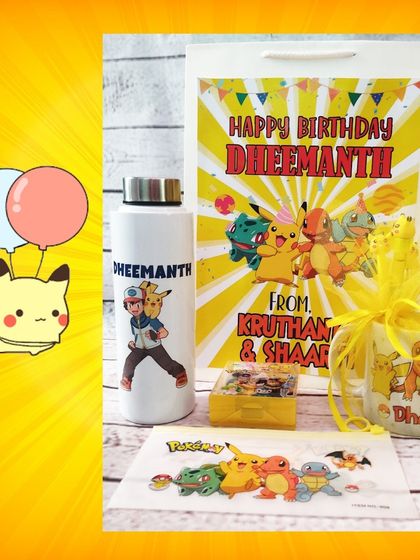 A closer look at the personalized Pokémon water bottle and wrapped mug, presented with a custom happy birthday paper bag.