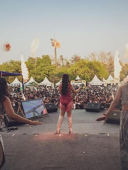 The view from behind the dancers, looking out at the massive crowd and pyrotechnics. It's an incredible feeling to perform for so many people.