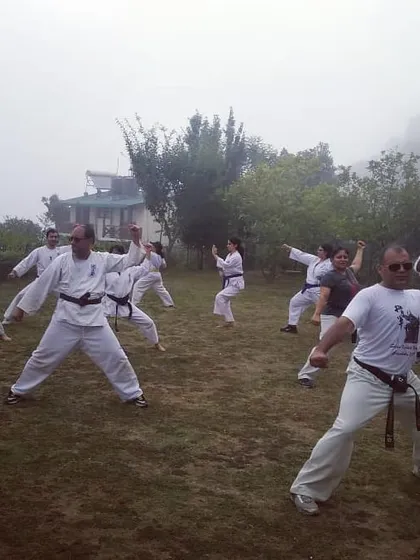 Training is not confined to the dojo walls. Here, our students practice their kata amidst the misty mornings of our annual mountain training camp, or Gasshuku.