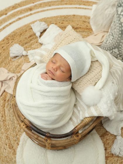 Tucked into a cozy basket with a cute little sleepy hat. This is just perfection. I love creating these warm, snuggly setups for newborn photos.