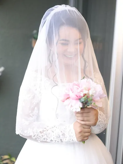 Another lovely shot of the bride behind her veil. The soft focus adds to the dreamy, romantic quality of the moment, with her radiant makeup glowing softly.