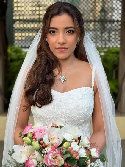 Holding her bouquet, she looks like a dream. The makeup is designed to be transfer-proof and photograph beautifully, ensuring she looks perfect all day.
