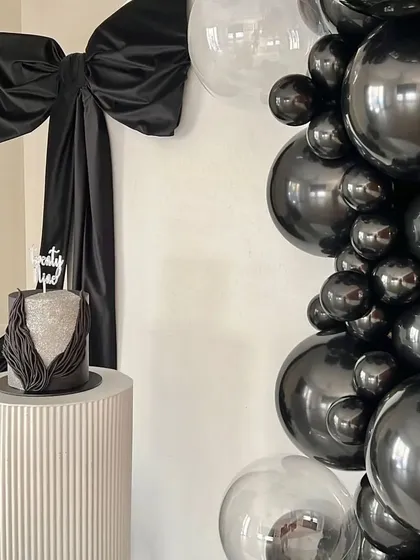 A close-up showing the cake and its placement within the chic, monochrome decor.