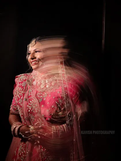 A slow-shutter speed effect captures the bride's movement and joy, creating a unique and artistic wedding photo.