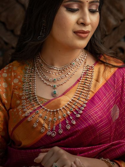 A close-up on the stunning diamond necklace, which adds a touch of modern glamour to the traditional saree.