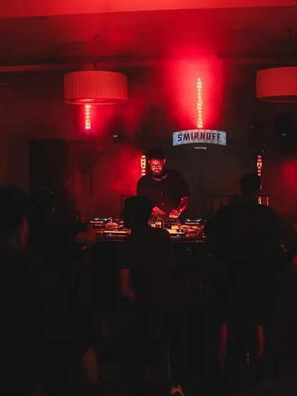 The DJ booth at the center of the action, with the crowd gathered around. This setup creates a unique connection between the artist and the audience.