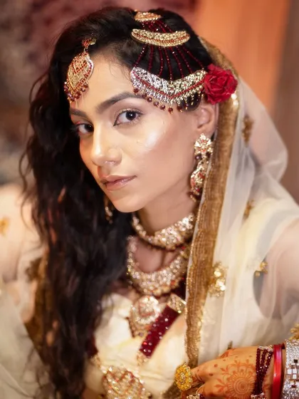 A close-up portrait focusing on the stunning hair jewelry and soft, glowing makeup, a testament to my student's skill.