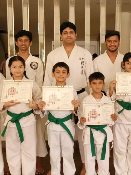 A group of students who have earned their green belts at the Virar branch distribution event.