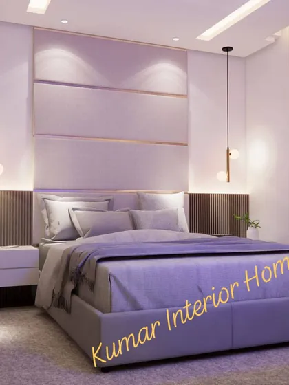 A cozy bedroom with a lavender lighting theme. The design includes a padded headboard with gold inlay and stylish pendant lights.