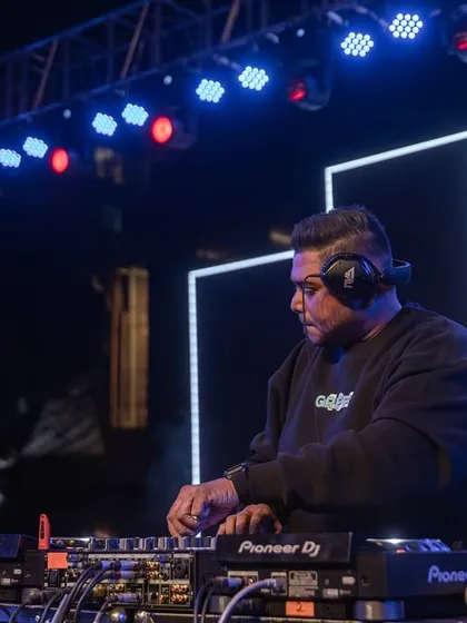Focused on the mix at RGIT College, with the stage lights setting the mood. I use professional Pioneer DJ gear to deliver a flawless set every time.