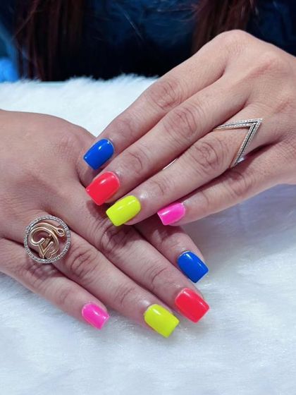A vibrant pop of color with this neon set. The square-shaped nails are painted in bold, solid shades of blue, red, yellow, and pink for a look that's playful and impossible to ignore.