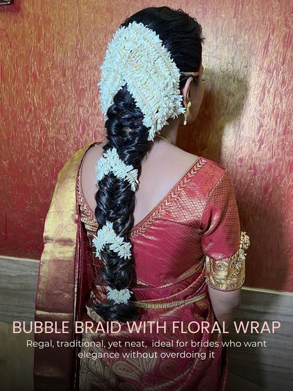 A regal and neat bubble braid with a floral wrap, ideal for South Indian brides who want elegance without overdoing it.