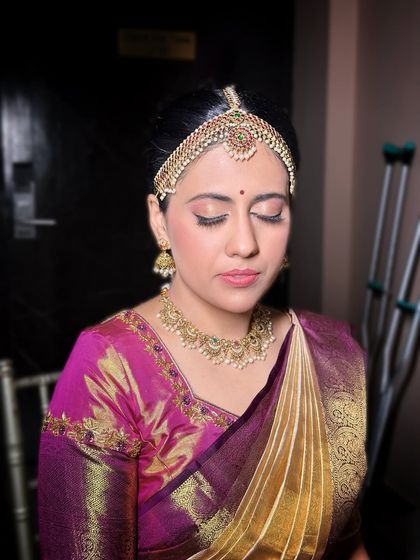 A close-up on the makeup, showing the soft pink tones on the eyes and the flawless skin finish.